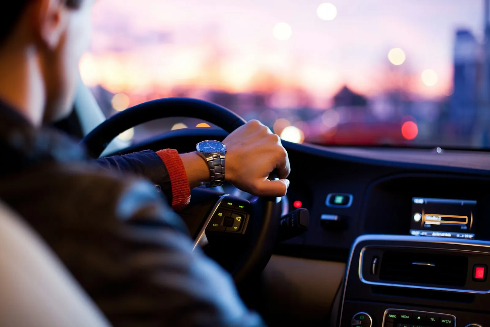 Driver at the wheel of a rental car on an open road